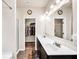 Well-lit bathroom with double sinks and large mirror, plus an entrance to the walk-in closet at 637 Sunflower Dr, Canton, GA 30114