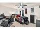 Well-lit bedroom with desk and gaming chair, bed with colorful pillows, and accent decor at 637 Sunflower Dr, Canton, GA 30114