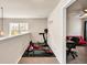 Versatile bonus room with workout area plus view of a room with a desk and red futon at 637 Sunflower Dr, Canton, GA 30114