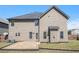Exterior of home with a flat backyard including a small brick patio, grass, and utilities at 640 Parkside Place Dr, Mcdonough, GA 30253