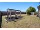 Large backyard features outdoor pergola with seating, fire pit, shed, and wood privacy fence at 640 Parkside Place Dr, Mcdonough, GA 30253