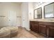 Bathroom with double vanities and dark wood cabinets at 640 Parkside Place Dr, Mcdonough, GA 30253