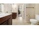 Bathroom with double sinks and entry into the bedroom and toilet at 640 Parkside Place Dr, Mcdonough, GA 30253