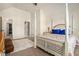 Bright bedroom with vaulted ceilings, a four-poster bed, ensuite bathroom, and walk in closet at 640 Parkside Place Dr, Mcdonough, GA 30253