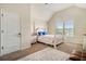 Cozy bedroom featuring a four-poster bed, neutral walls, and bright natural light from a window at 640 Parkside Place Dr, Mcdonough, GA 30253