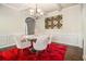 Sophisticated dining room featuring a round table, a modern chandelier, and a striking red rug, creating an elegant space at 640 Parkside Place Dr, Mcdonough, GA 30253