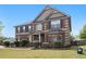 Attractive two-story brick home features manicured landscaping, a welcoming entrance, and traditional architectural details at 640 Parkside Place Dr, Mcdonough, GA 30253