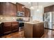 Well-equipped kitchen with stainless steel appliances, granite countertops, an island, and rich wood cabinetry at 640 Parkside Place Dr, Mcdonough, GA 30253