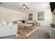A living room with neutral paint, an area rug, and multiple sofas and tables at 640 Parkside Place Dr, Mcdonough, GA 30253