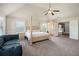 Open and airy main bedroom featuring a ceiling fan, sitting area, and an ensuite bathroom at 640 Parkside Place Dr, Mcdonough, GA 30253