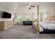 Bright main bedroom with a four poster bed, accent wall, and a flat screen television at 640 Parkside Place Dr, Mcdonough, GA 30253
