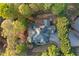 A bird's eye view of an elegant home, with a private driveway surrounded by lush green foliage, creating a secluded feel at 519 River Estates Pkwy, Canton, GA 30115