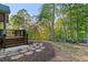 Backyard stone pathway leading to a wood deck and beautiful yard at 519 River Estates Pkwy, Canton, GA 30115