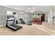 Finished basement area featuring a treadmill, rowing machine, dining table, and windows at 519 River Estates Pkwy, Canton, GA 30115
