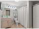 Bathroom featuring a marble vanity, decorative mirror, and a shower with stylish curtain at 519 River Estates Pkwy, Canton, GA 30115