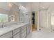 Bathroom with double vanity, white marble countertops, and framed mirrors at 519 River Estates Pkwy, Canton, GA 30115