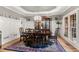 Elegant dining room with wood table, chandelier, wainscoting, and large windows at 519 River Estates Pkwy, Canton, GA 30115