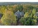 Exterior shot featuring a gorgeous home nestled among towering trees and lush greenery, emphasizing a private setting at 519 River Estates Pkwy, Canton, GA 30115