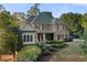 Charming stone facade home with lush landscaping, dormer windows, and inviting front porch at 519 River Estates Pkwy, Canton, GA 30115