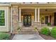 Inviting front porch with stone columns, double doors, and decorative wreaths at 519 River Estates Pkwy, Canton, GA 30115
