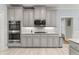 Charming kitchen features gray cabinets, stainless steel appliances, and beautiful marble countertops at 519 River Estates Pkwy, Canton, GA 30115