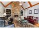Stunning living room with stone fireplace, hardwood floors, and exposed beam ceilings at 519 River Estates Pkwy, Canton, GA 30115