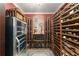 Custom wine cellar with wine fridge, wine racks, accent lighting, and decorative mirror at 519 River Estates Pkwy, Canton, GA 30115