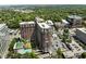 Aerial view showcases the building's architecture, surrounding greenery, pool, and parking area at 1820 Peachtree Nw St # 1008, Atlanta, GA 30309