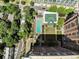 Aerial view of a building showcasing a beautiful pool, lounge chairs, green roof and garden areas surrounded by lush trees at 1820 Peachtree Nw St # 1008, Atlanta, GA 30309