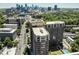 A high-rise apartment building surrounded by greenery with a cityscape view in the background at 1820 Peachtree Nw St # 1008, Atlanta, GA 30309