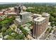 Expansive aerial view showing a swimming pool nestled among several buildings and lush greenery at 1820 Peachtree Nw St # 1008, Atlanta, GA 30309