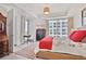 Comfortable bedroom featuring a large window with city views, a workspace, and plenty of natural light at 1820 Peachtree Nw St # 1008, Atlanta, GA 30309
