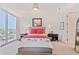 Bright bedroom featuring a large window with city views, comfortable furnishings, and ample closet space at 1820 Peachtree Nw St # 1008, Atlanta, GA 30309