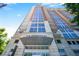 Striking view of The Brookwood exterior showing soaring height, multi-paned windows, and porte-cochere at 1820 Peachtree Nw St # 1008, Atlanta, GA 30309