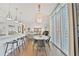 Stylish eat-in kitchen with stainless appliances, bar seating, and an adjacent dining area and living room at 1820 Peachtree Nw St # 1008, Atlanta, GA 30309
