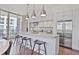 Modern kitchen with stainless steel appliances, white cabinetry, and a kitchen island with stool seating at 1820 Peachtree Nw St # 1008, Atlanta, GA 30309