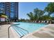 Community pool surrounded by comfortable lounge chairs and lush landscaping, perfect for relaxation at 1820 Peachtree Nw St # 1008, Atlanta, GA 30309