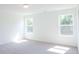 Bright, white bedroom with natural light from two windows and neutral carpet at 2117 Boxwood Se Cir, Conyers, GA 30094