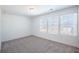 Bright bedroom featuring plush carpeting and multiple windows for ample natural light at 2117 Boxwood Se Cir, Conyers, GA 30094