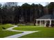 Picturesque community green space with pergola, benches, walking path, and mature trees at 2117 Boxwood Se Cir, Conyers, GA 30094