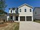Charming two-story home with a two-car garage and manicured front lawn, perfect for suburban living at 2117 Boxwood Se Cir, Conyers, GA 30094