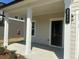 Inviting front porch with classic columns and a modern house number sign at 2117 Boxwood Se Cir, Conyers, GA 30094