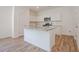 Modern kitchen with an island, granite countertops, stainless steel appliances, and white cabinets at 2117 Boxwood Se Cir, Conyers, GA 30094