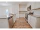 Well-equipped kitchen featuring stainless steel appliances, granite counters, and white cabinetry at 2117 Boxwood Se Cir, Conyers, GA 30094