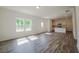 Spacious living room with modern flooring and ample natural light flowing to the kitchen area at 2117 Boxwood Se Cir, Conyers, GA 30094