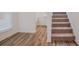 Carpeted staircase with natural light filtering through nearby windows at 2117 Boxwood Se Cir, Conyers, GA 30094
