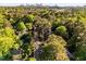 Expansive aerial view of a neighborhood with mature trees, showcasing proximity to city and highways at 2287 Armand Ne Rd, Atlanta, GA 30324