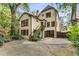 This home features a well-maintained backyard with lush greenery, patio, stairs, and a basketball hoop at 2287 Armand Ne Rd, Atlanta, GA 30324