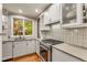 Bright kitchen with white cabinetry, modern appliances, and a view to the backyard at 2287 Armand Ne Rd, Atlanta, GA 30324