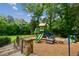 Community playground with slides and climbing structures surrounded by lush trees and greenery at 2287 Armand Ne Rd, Atlanta, GA 30324